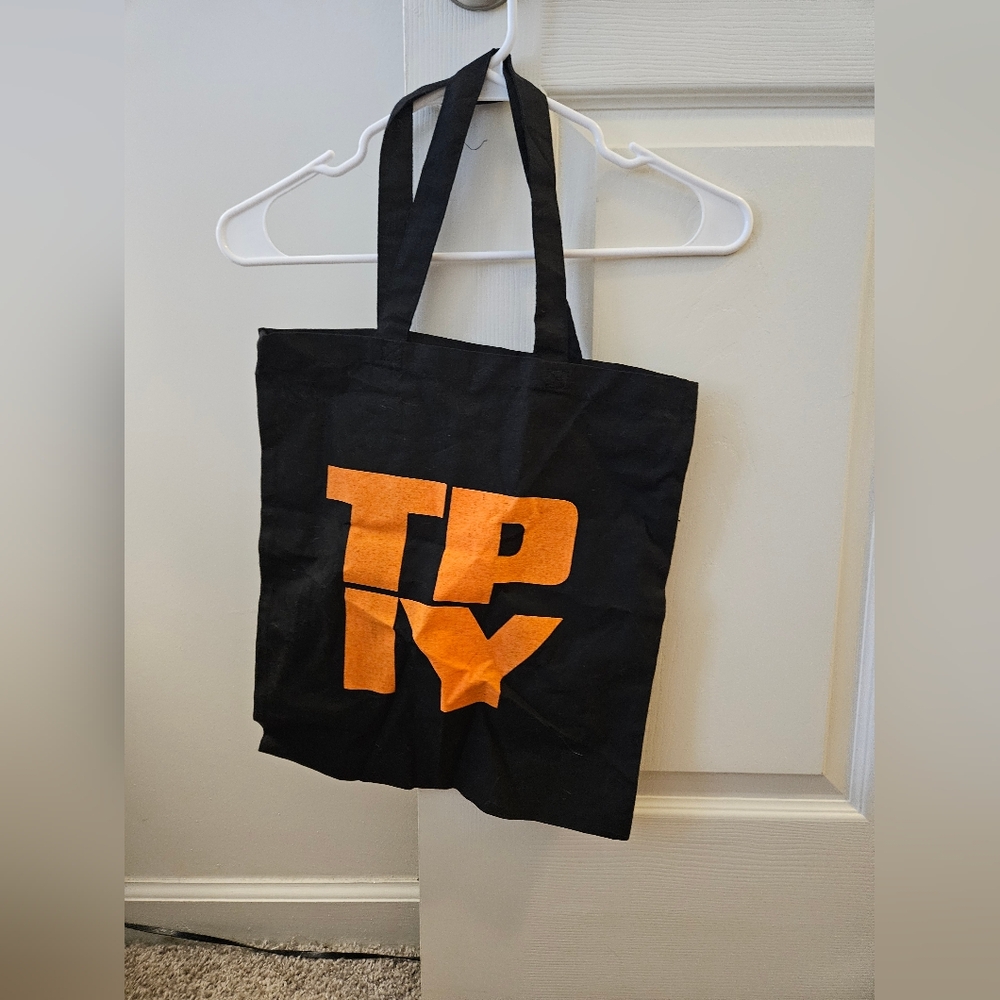 The Plot In You Band Merch Tote Bag Black Tote Bag with Orange Letters